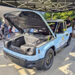 Slate Truck demonstration at Seattle event with the hood open beneath the Space Needle